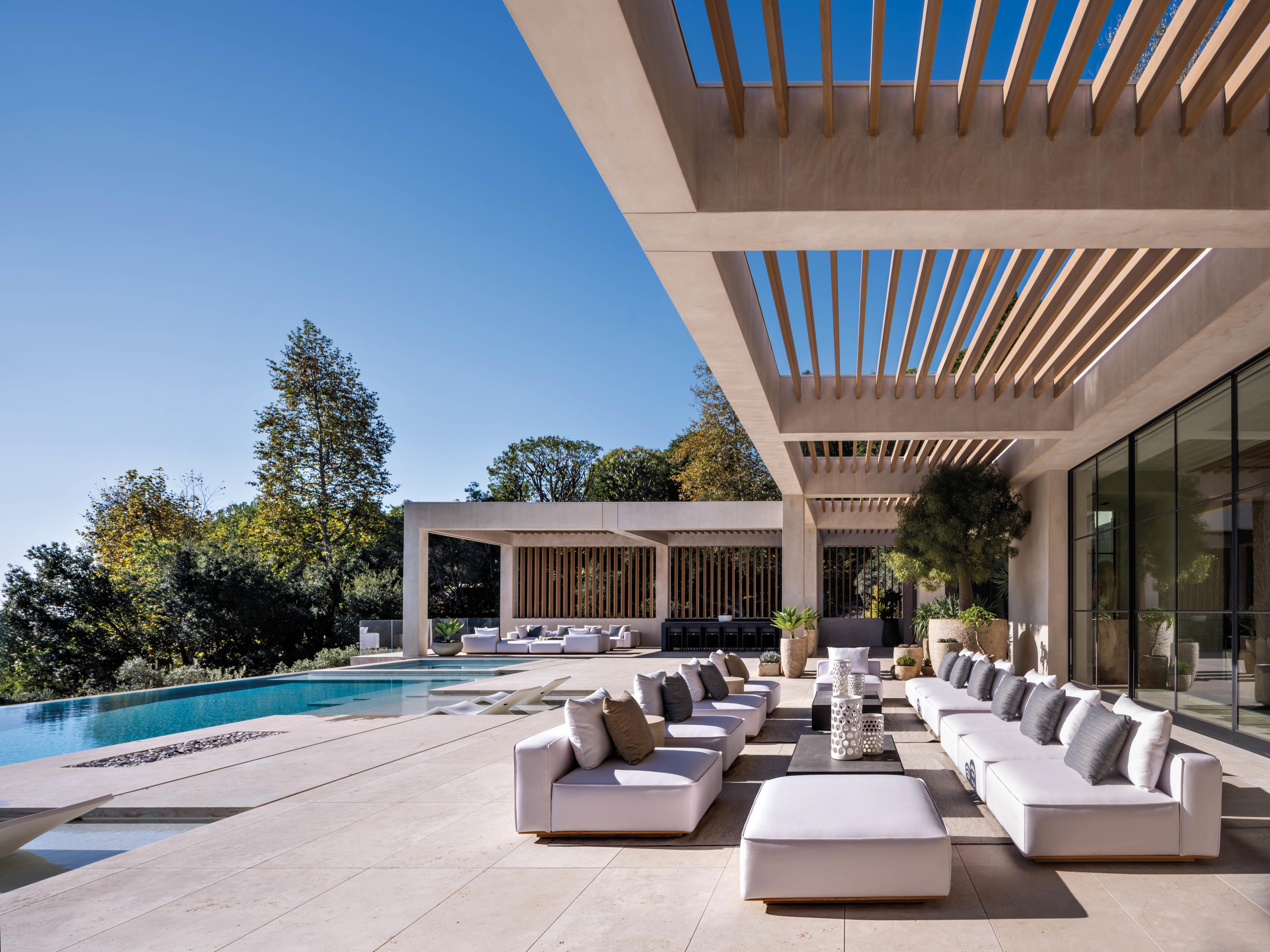 pool deck with modern furniture, pergola shading and outdoor bar