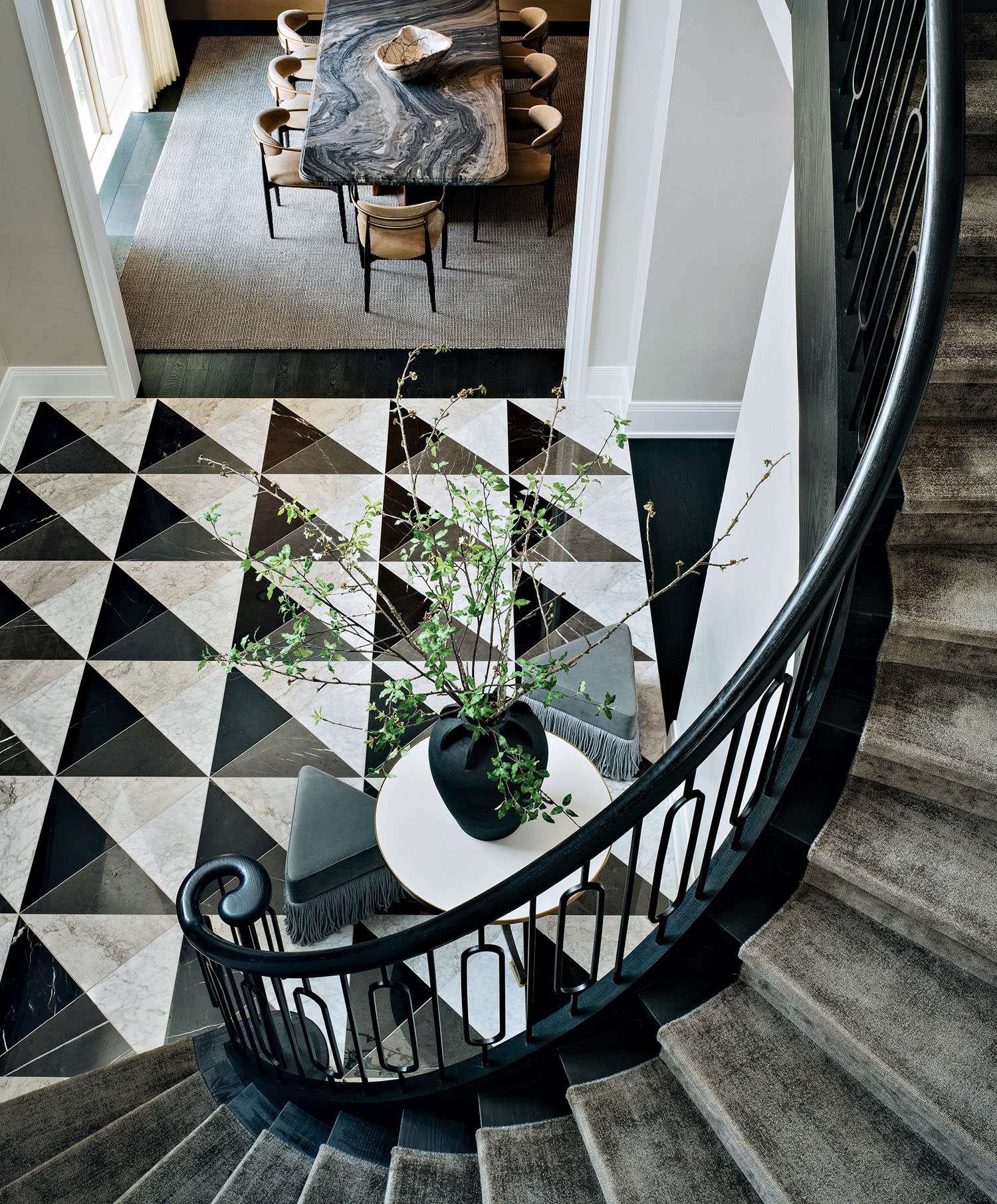 foyer with a checkerboard floor leading into a stairway
