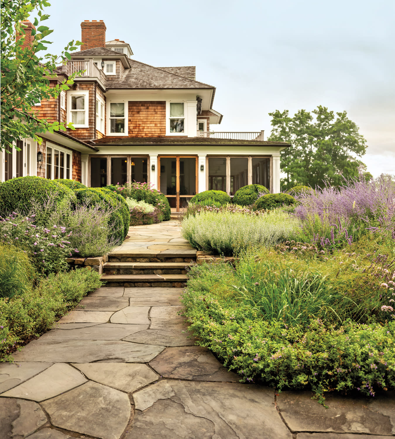 exterior of a classic Hamptons home with a screened-in porch