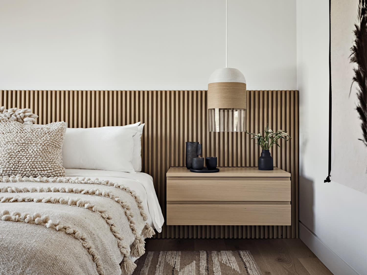 hotel suite-inspired bedroom with a reeded headboard