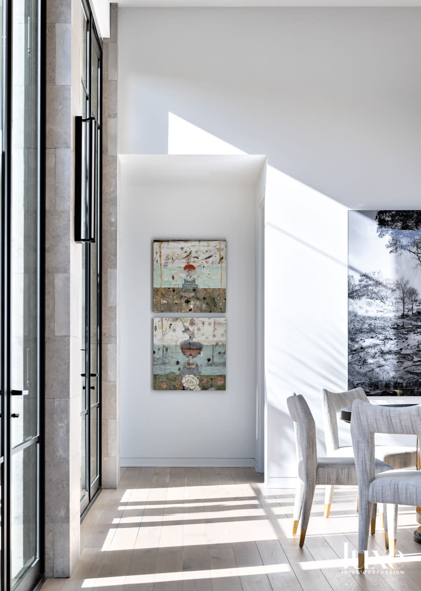 Dining area with table, chairs and art.