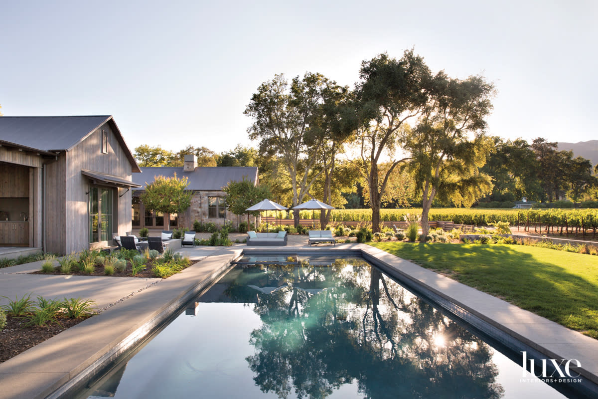 backyard with long pool and landscape grasses