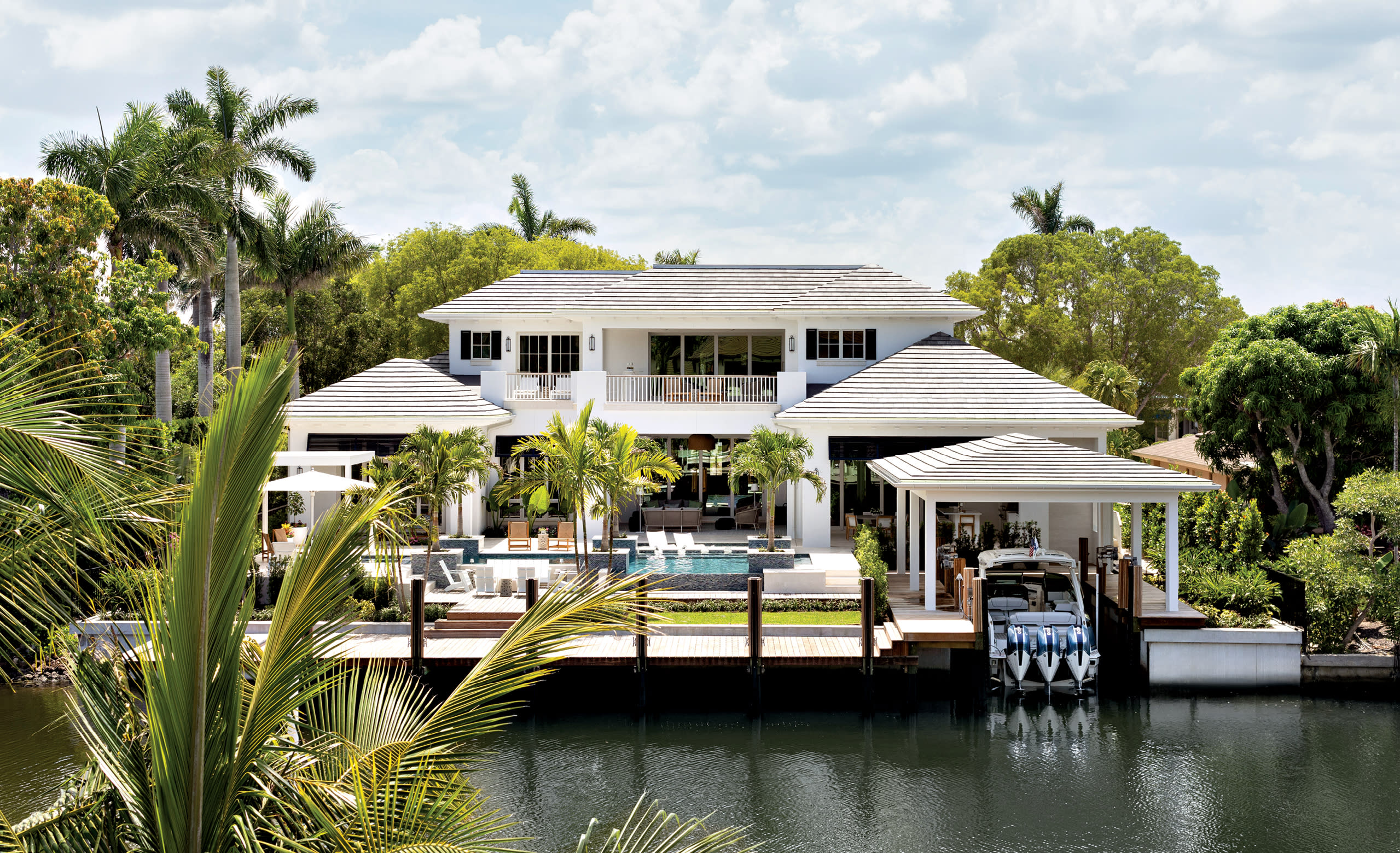 waterfront Naples home with a boat dock and pool