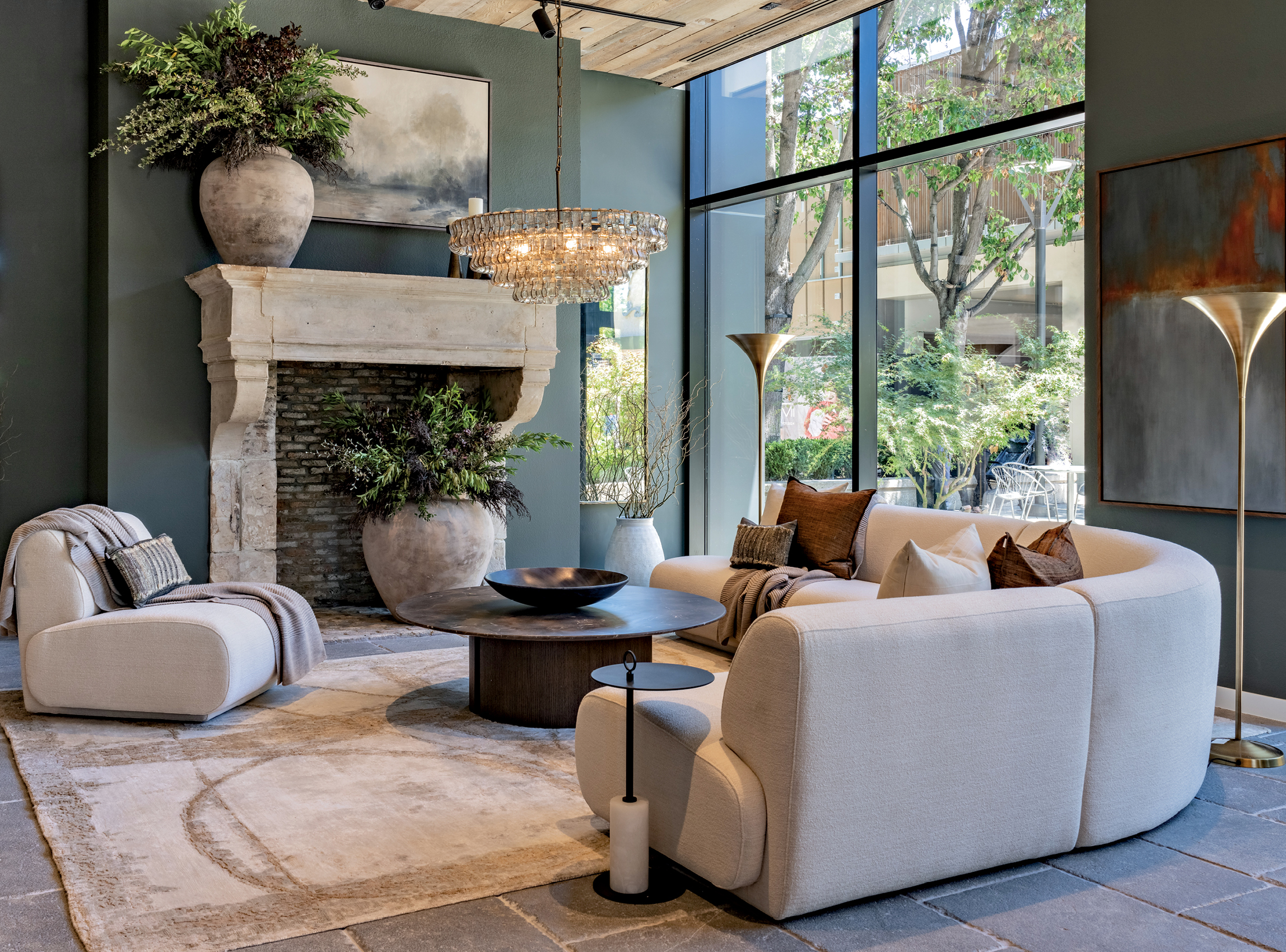 curving sectional in front of a stone fireplace mantle in Arhaus's Stanford Shopping Center