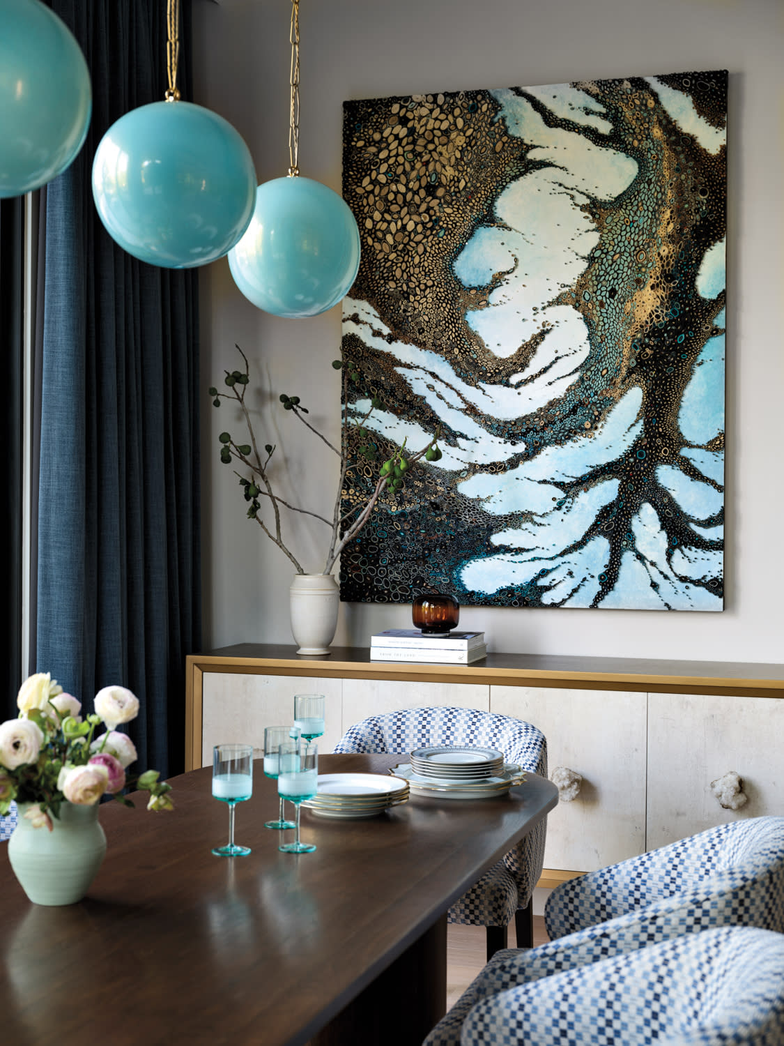 Blue light fixtures hang over the dining table.