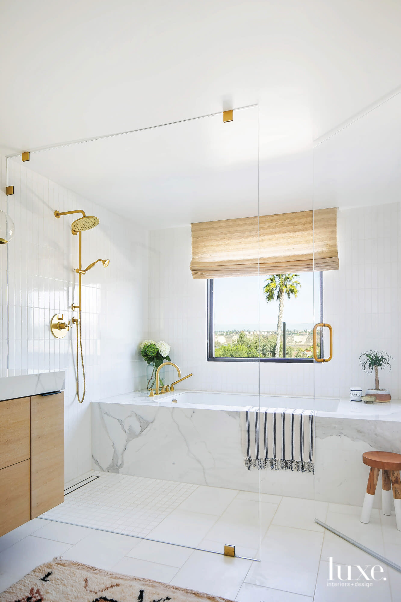 View of master bath facing tub with window and motorized shades