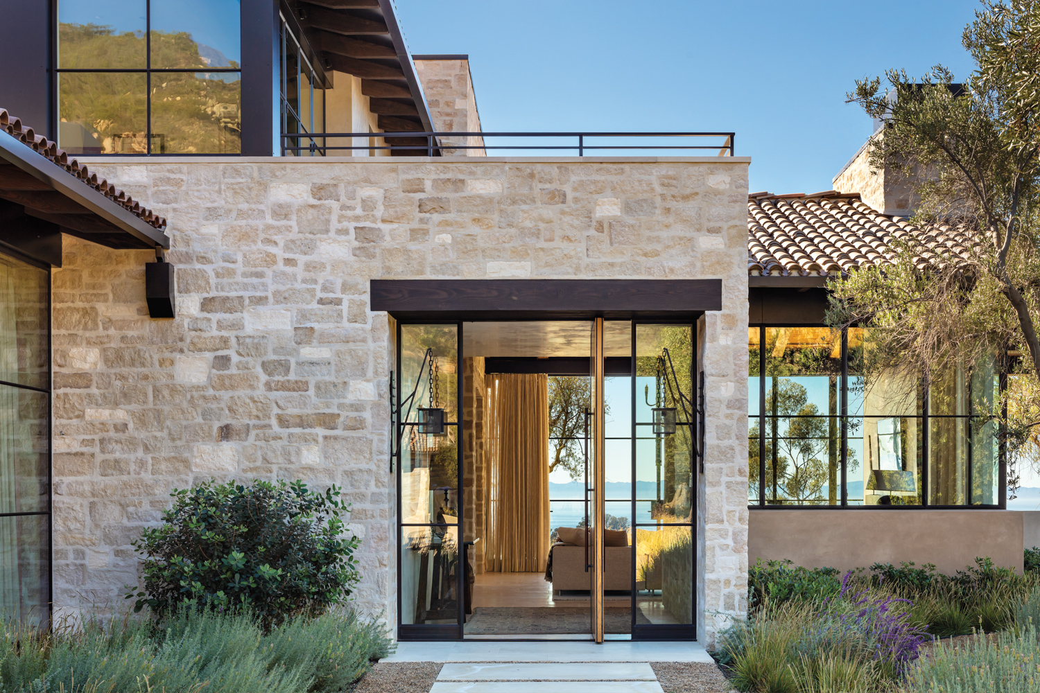 pivot door open beneath wood lintel entryway