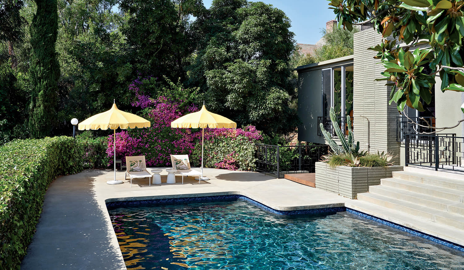 pool patio with two yellow umbrellas