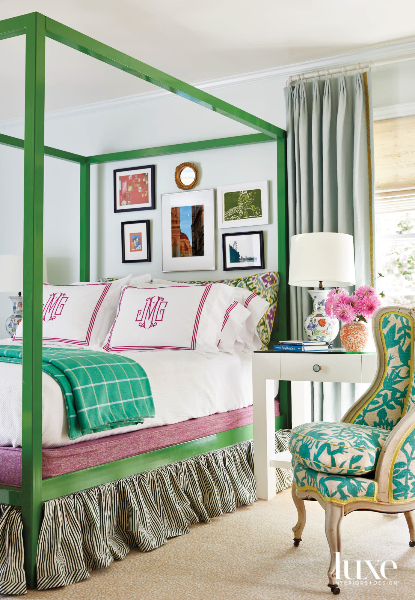 Green canopy bed with green and mulberry-colored linens