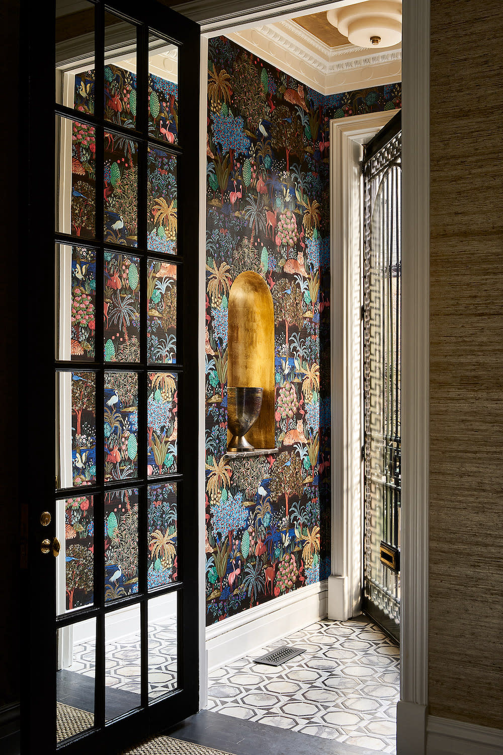 Colorful wallpaper in the this foyer makes for a cheerful entry.