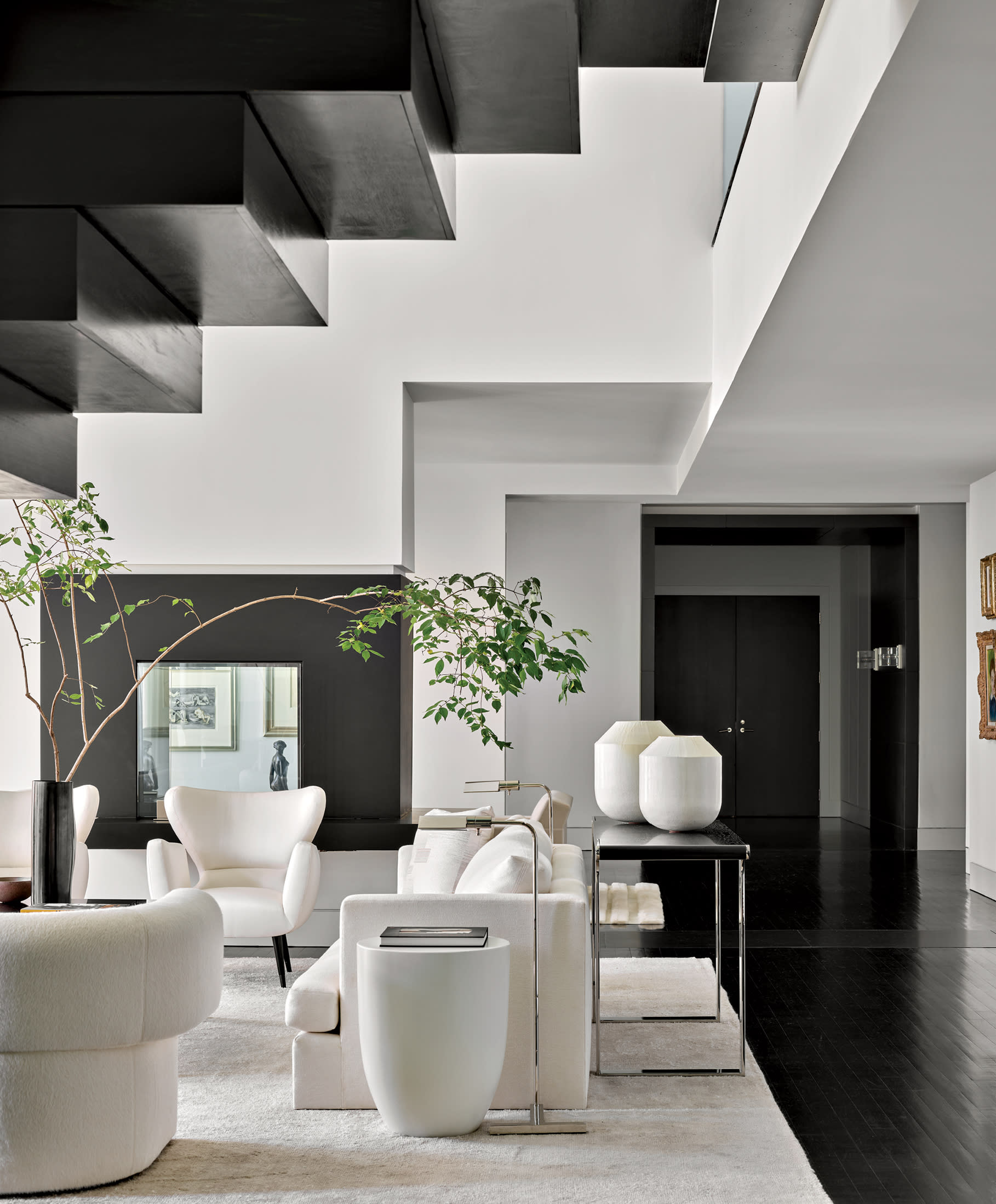 modern staircase rising over a white sleek living room