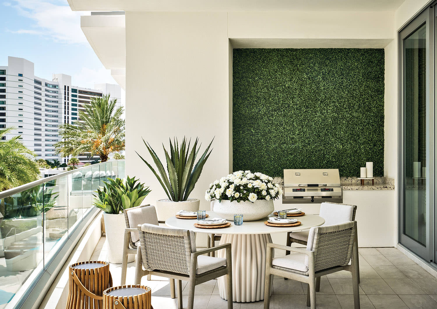 terrace of a Sarasota home with RH chairs and a Holly Hunt dining table