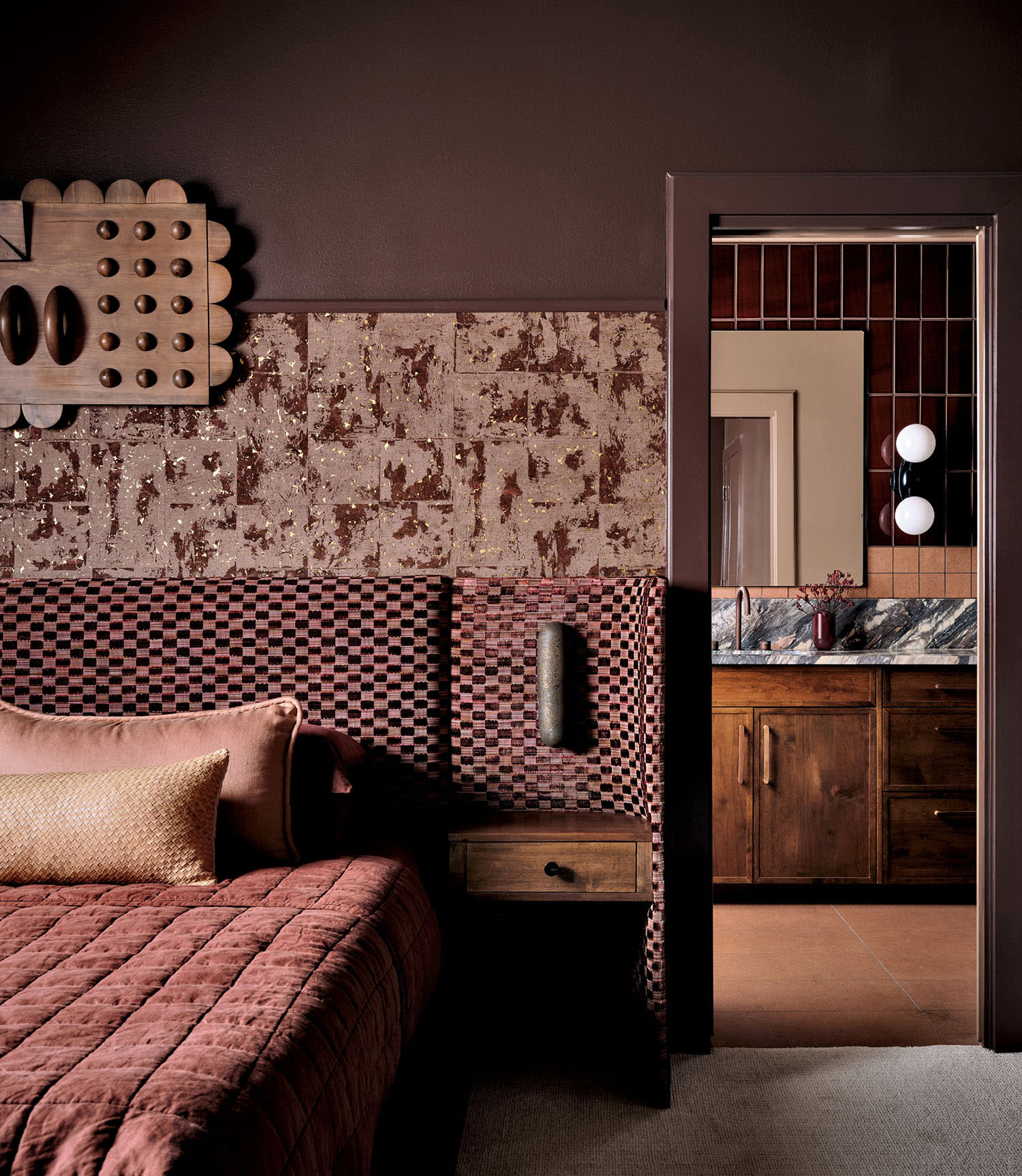 reddish-purple bedroom with velvet linens