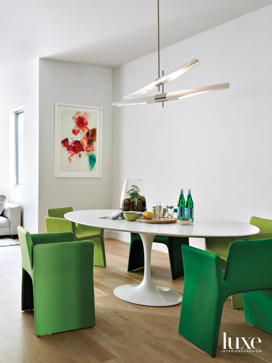 modern oblong white table with green chairs