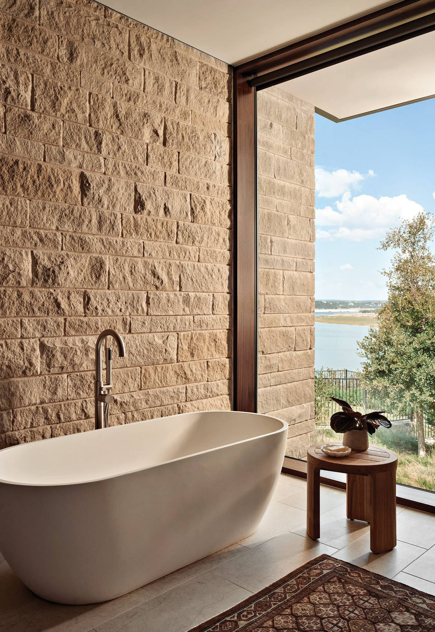 organic-style bathroom with views of Lake Travis from the tub