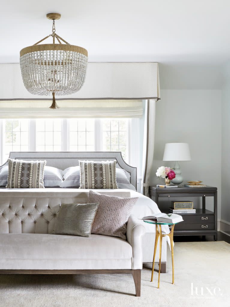 To maximize space in the master bedroom, Alex placed the Vanguard Furniture bed in front of the main window. Celebrating the unconventional arrangement, she had a canopy made to hang above. At the foot of the bed, a Bernhardt settee encourages relaxation.