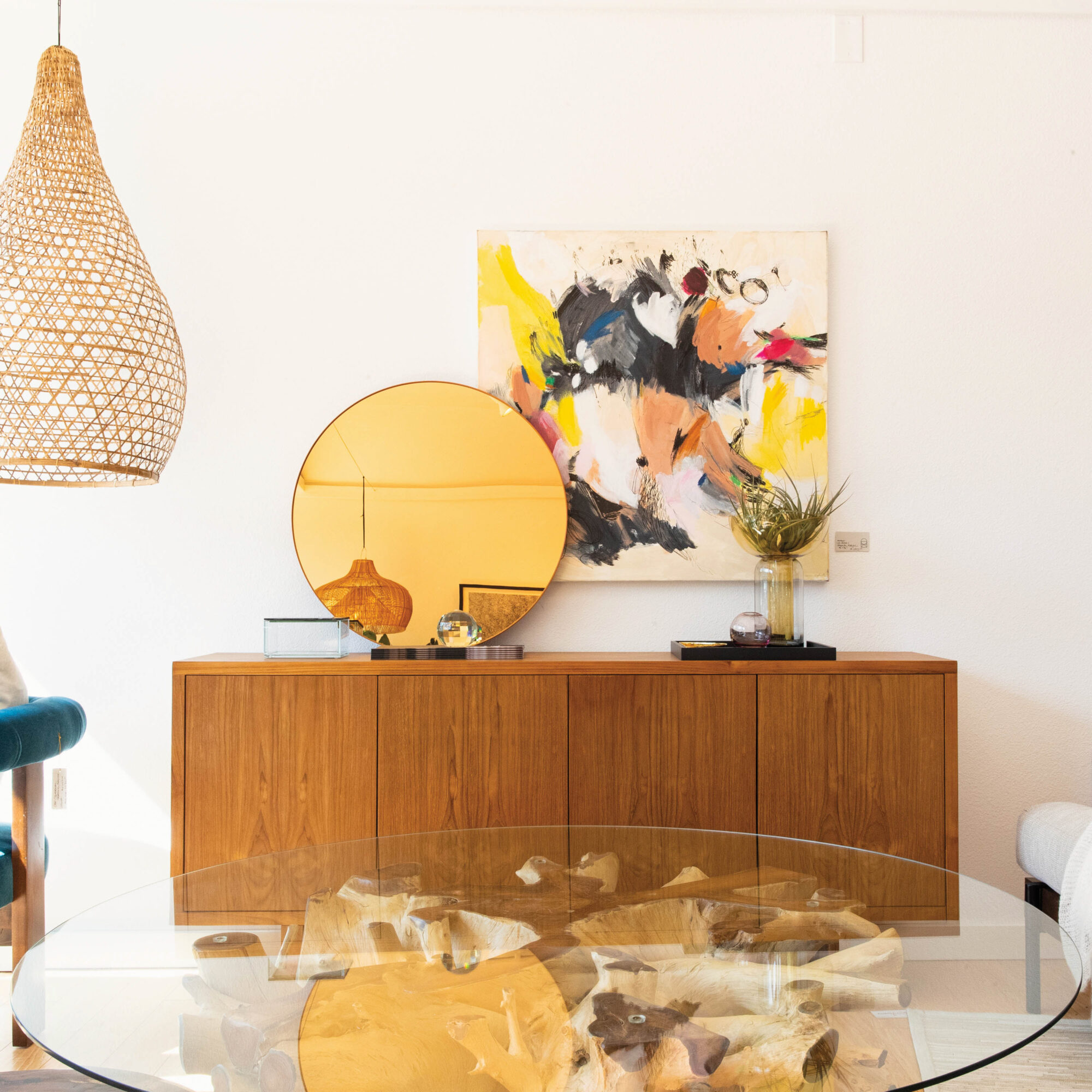 vignette of cabinet with yellow mirror and painting