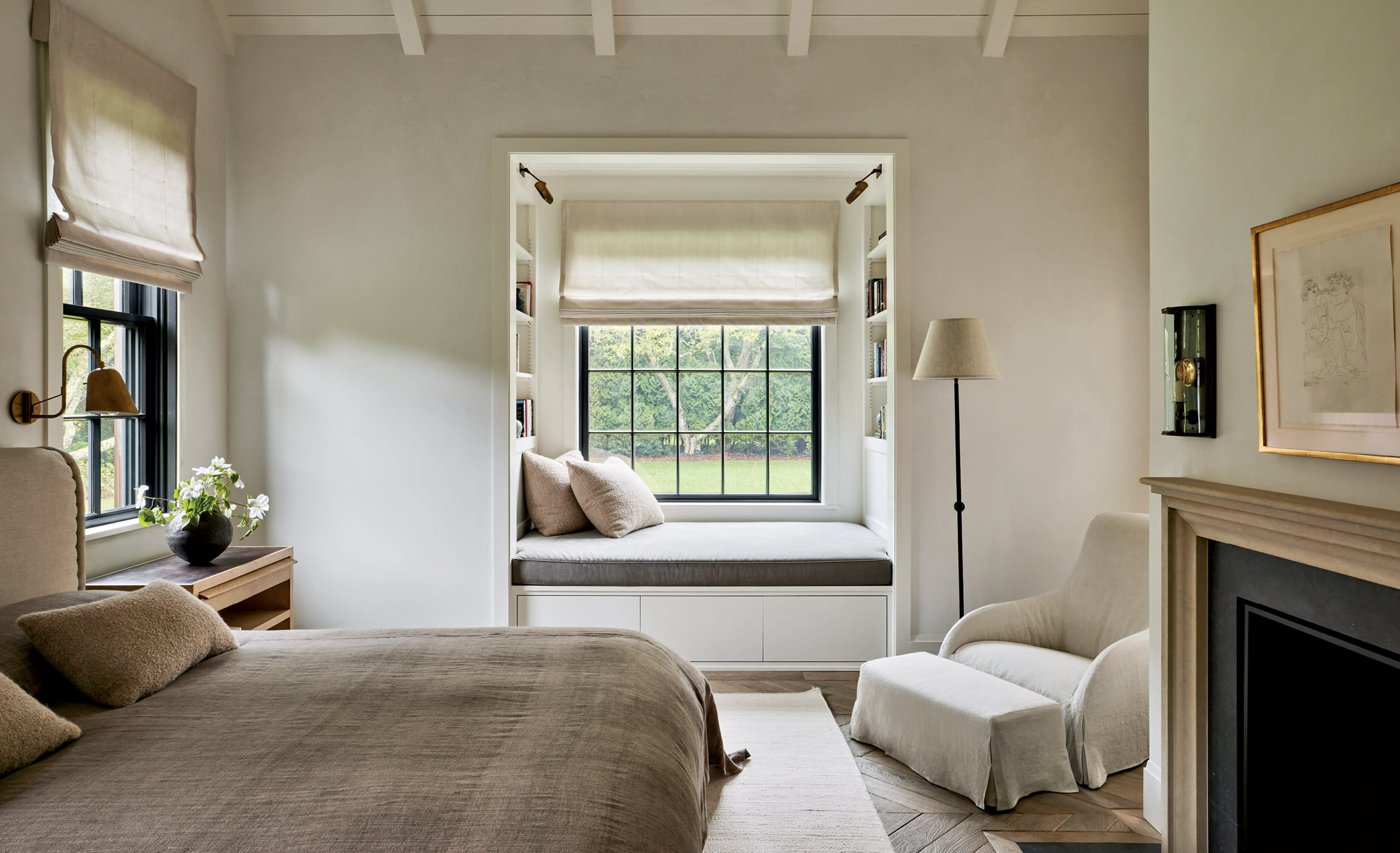 cozy primary bedroom with natural tones and window seat