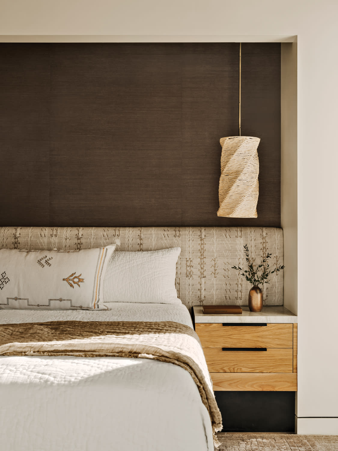contemporary bedroom with a grass cloth headboard
