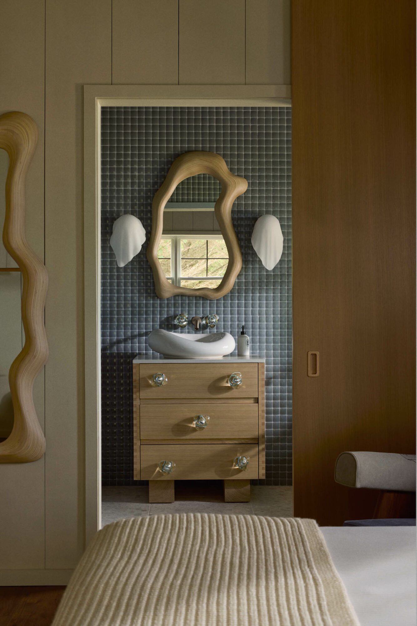 view of a blue tiled bathroom through a doorway