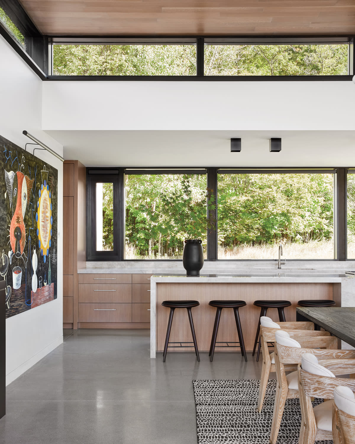 A sleek kitchen with quartzite countertops and white oak cabinetry.