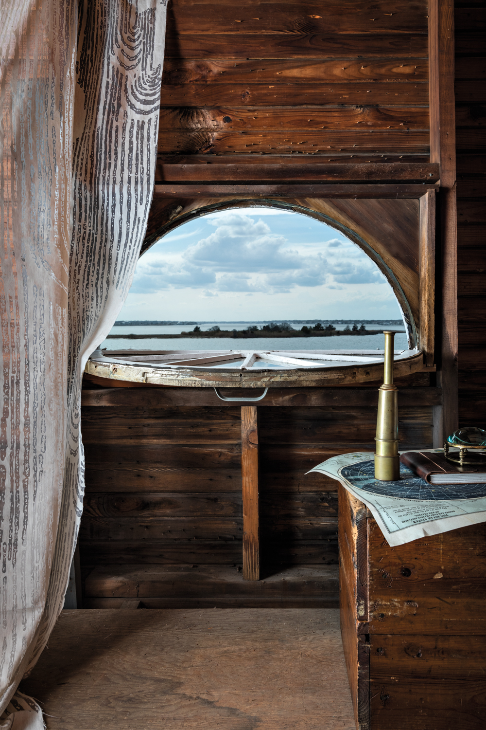 wood-look wallpaper draped over porthole