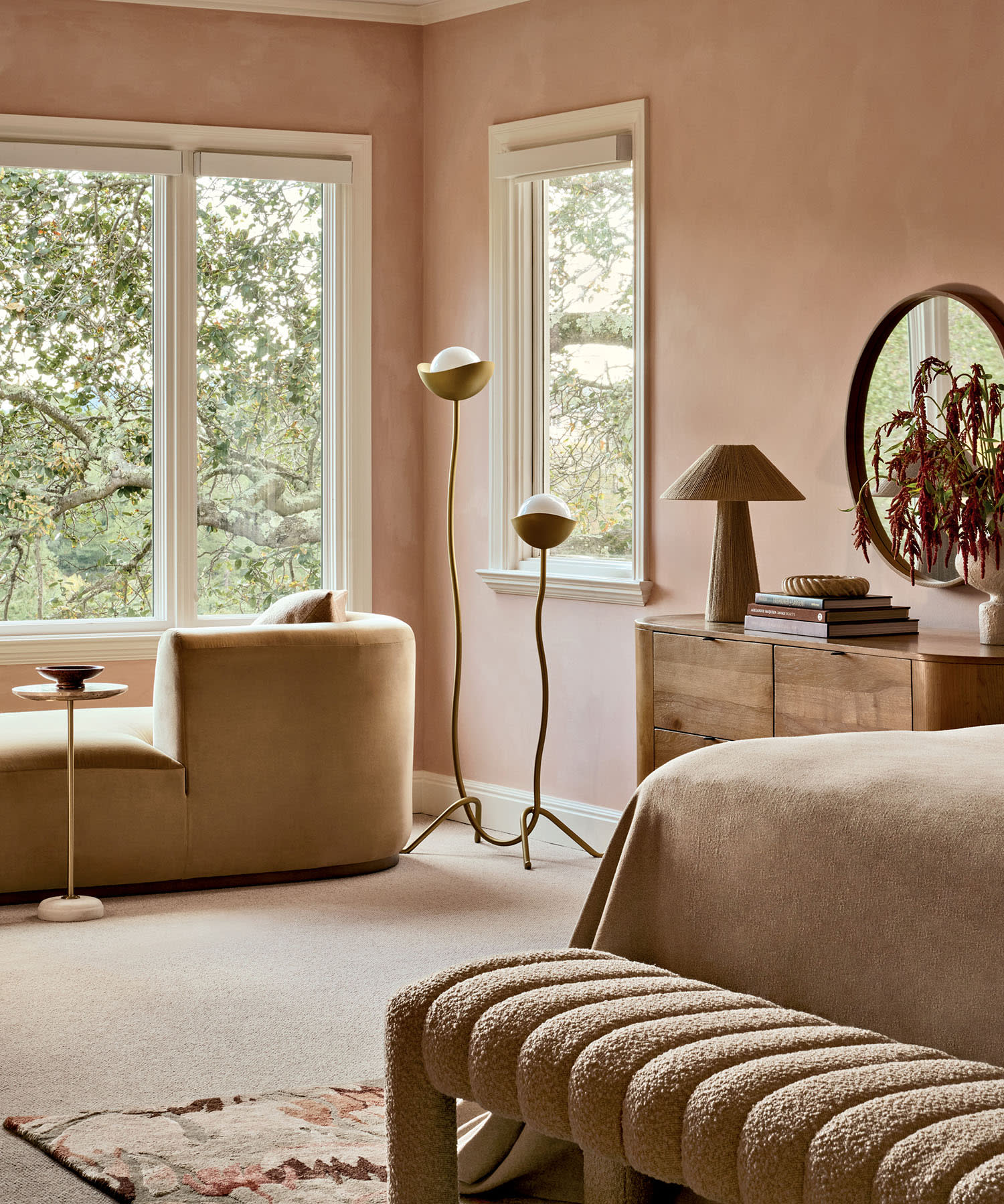 pink bedroom featuring a bed, a chair, a table, and a window allowing natural light to enter