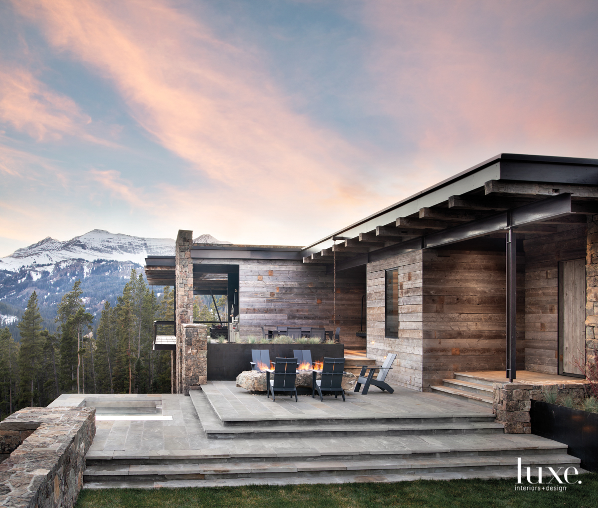 Big Sky, Montana house with view of mountains and patio with firepit.