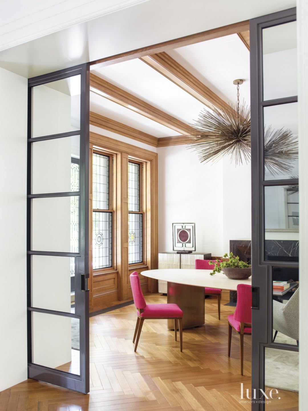 open door leading to dining room with hot pink chairs