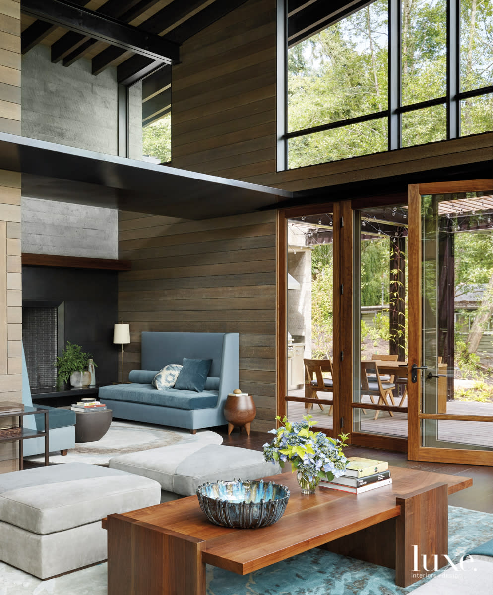 living area with table and two high back blue couches