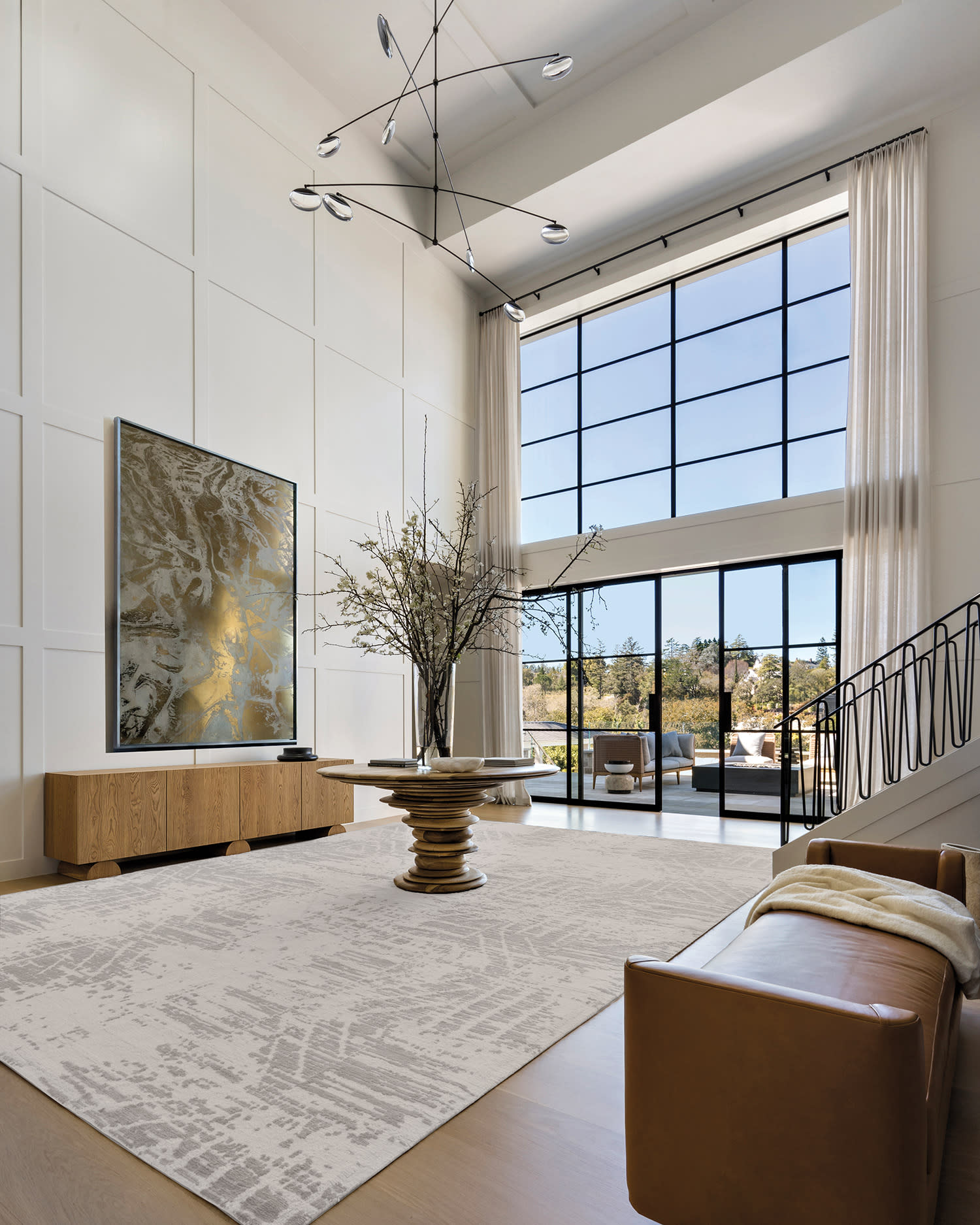 modern, white foyer with large windows and metallic accents