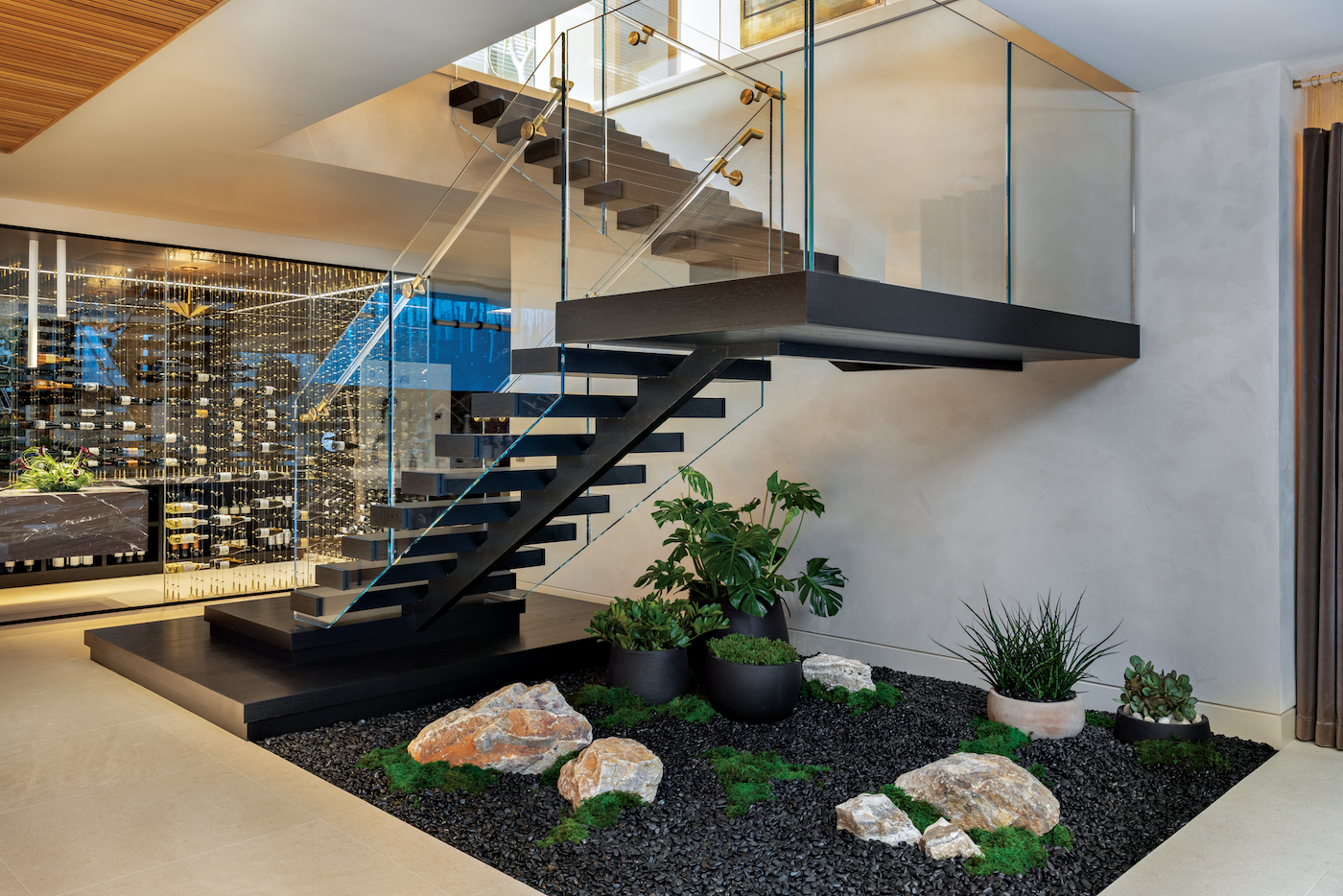 Floating staircase illuminated by natural light in a layered architectural interior.