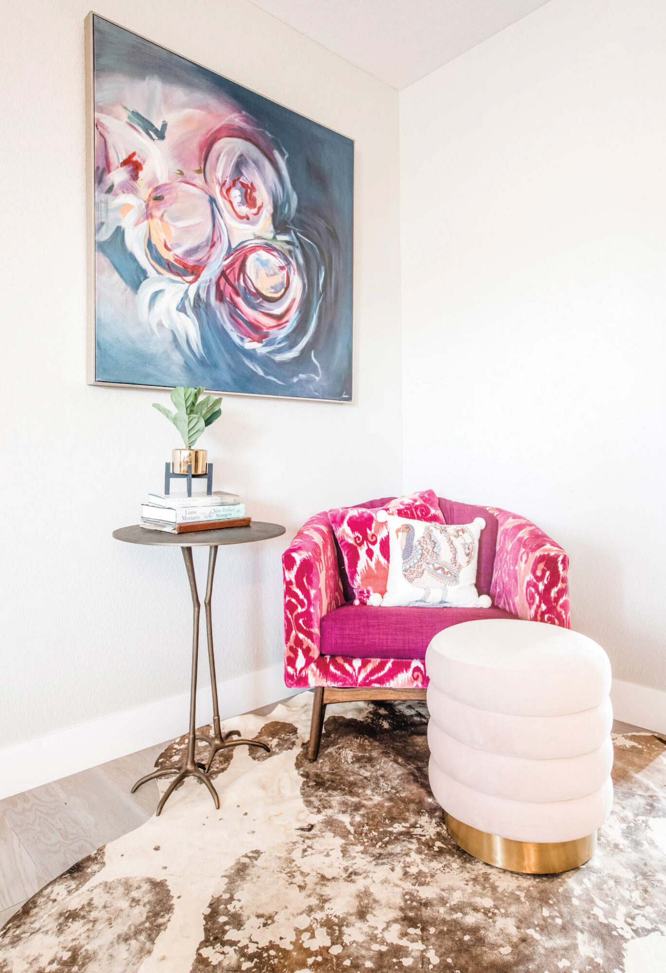 vignette of pink floral chair and floral painting