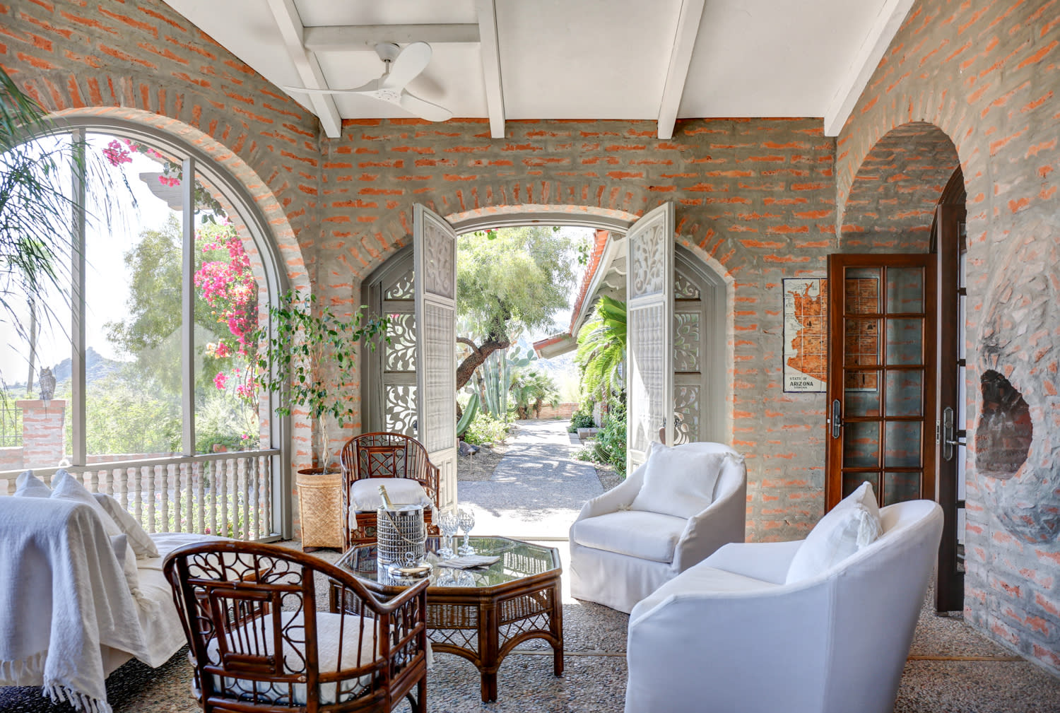 A spacious sun room featuring a large window and a comfortable couch, inviting natural light and relaxation.