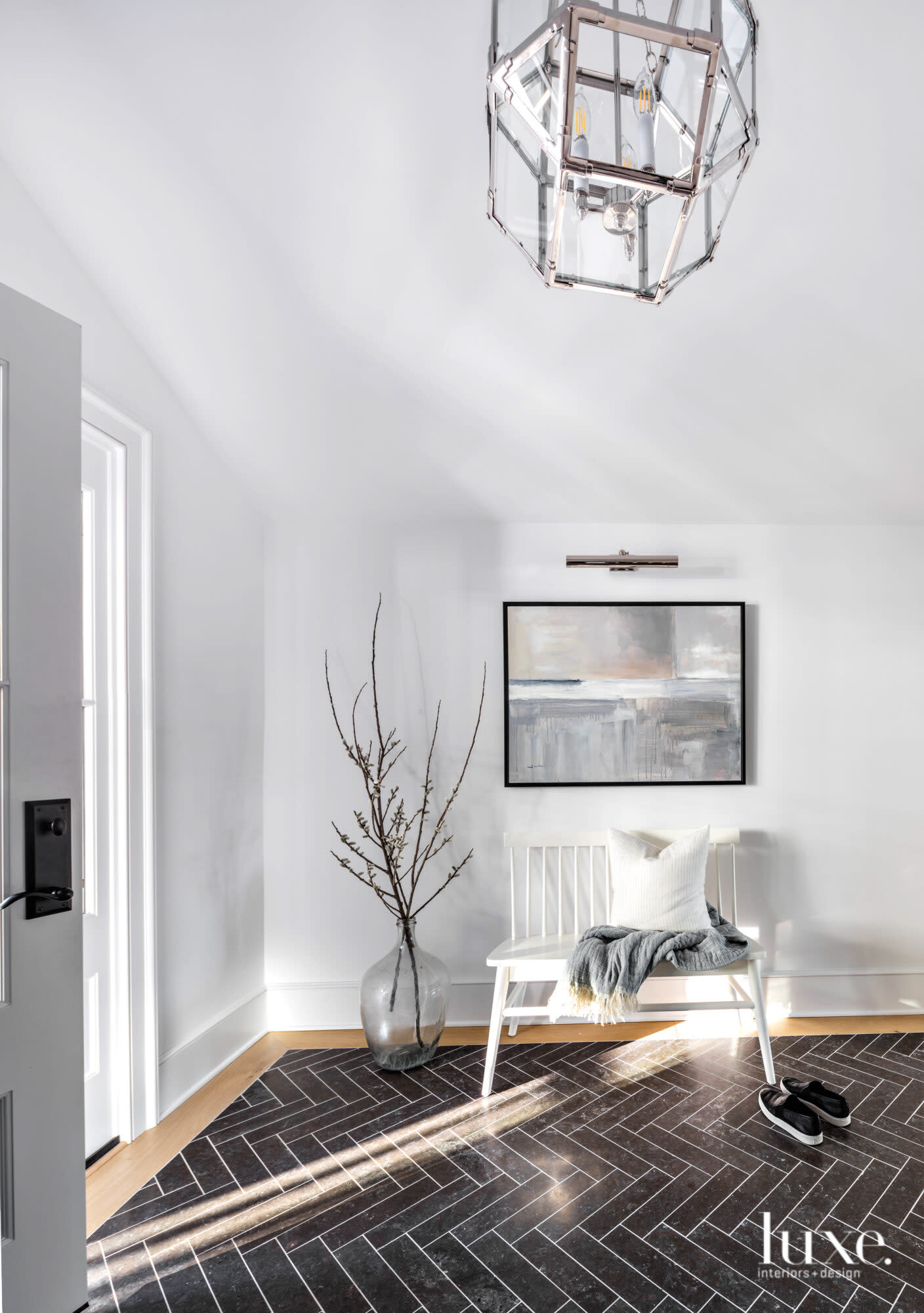Foyer of home with herringbone pattern on the floor