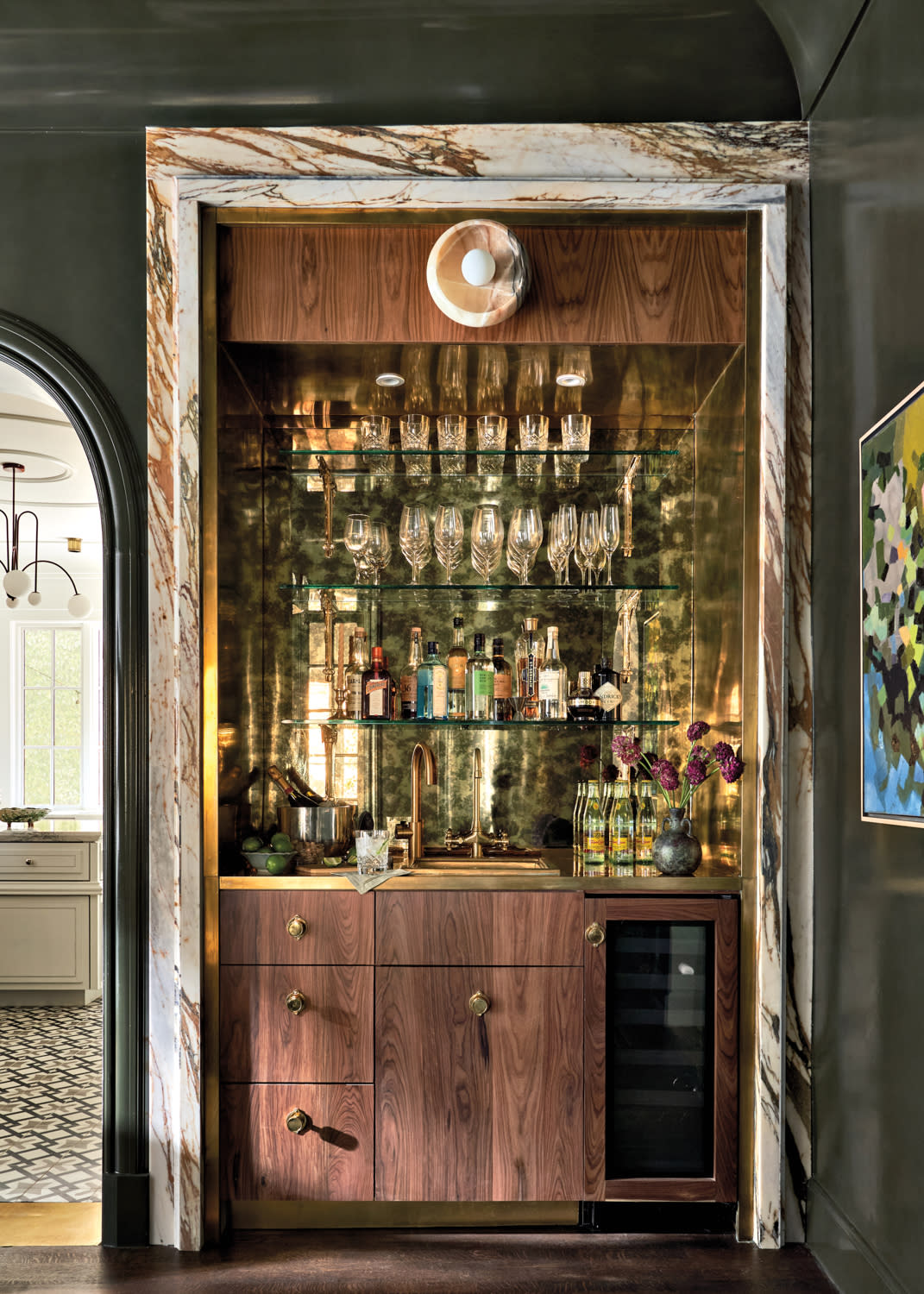 luxury home bar with a mirrored backsplash designed by Eddie Maestri