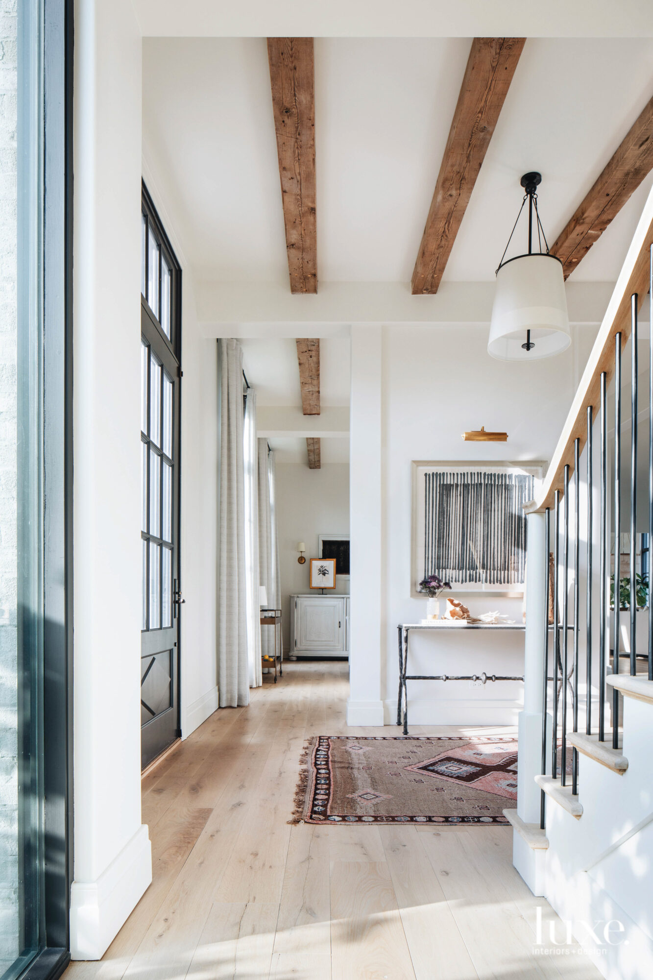 A bright entryway with Scandinavian, minimalistic touches give the space a clean look.