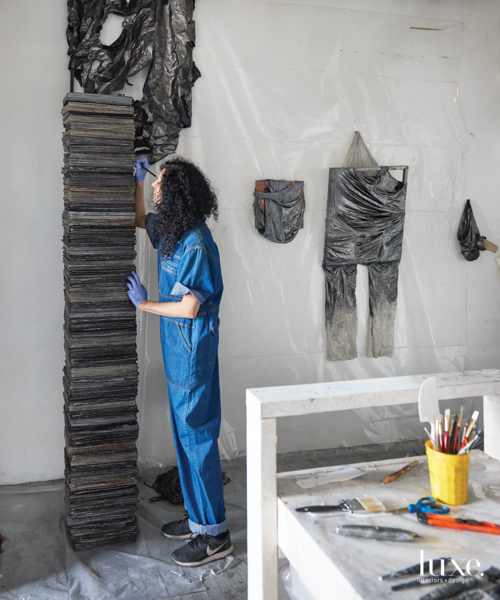 Seiden colors in The Future is Lost in Yesterday's News, which consists of hardened stacks of newspapers. Next to her hangs (left to right) Twisted Ego, Selfless Self Portrait and a work in progress.