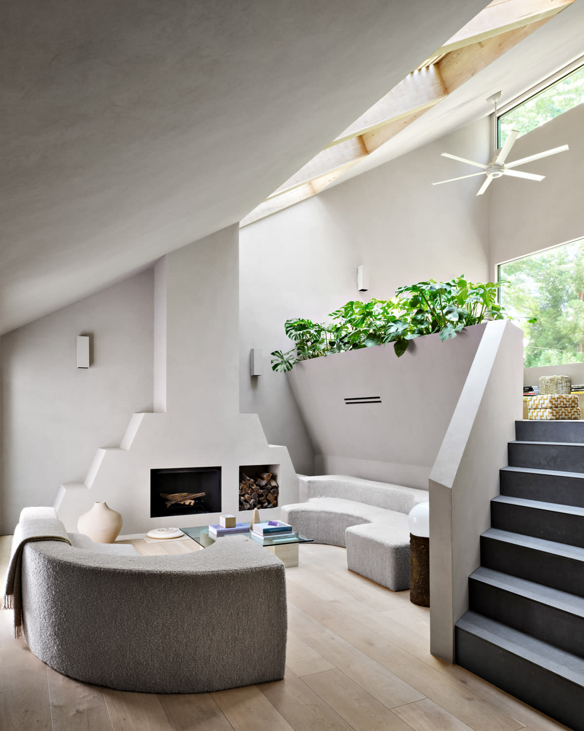 living room with a Mayan-inspired fireplace and lots of natural light coming in