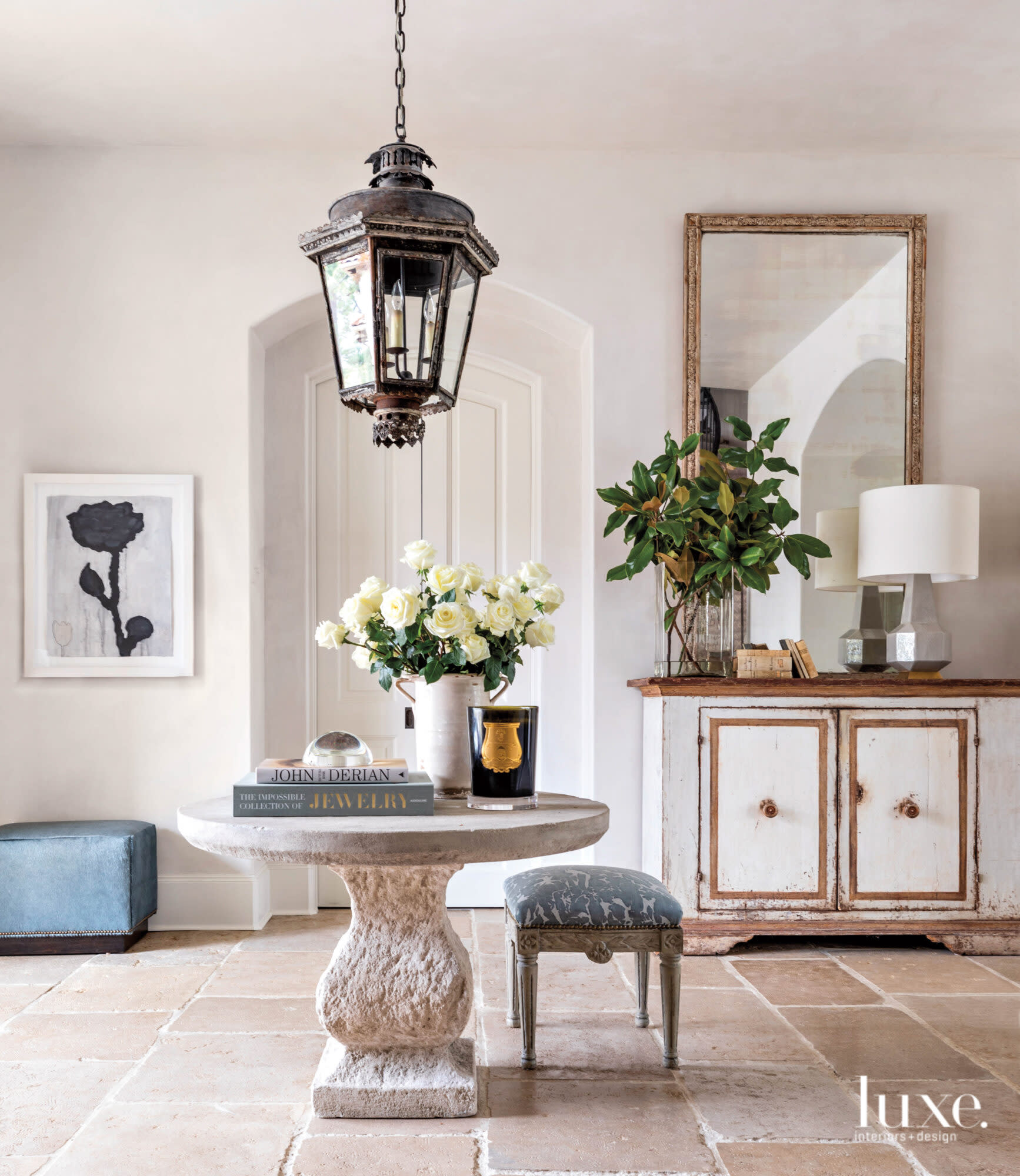 Light-filled entry with center table and lantern.