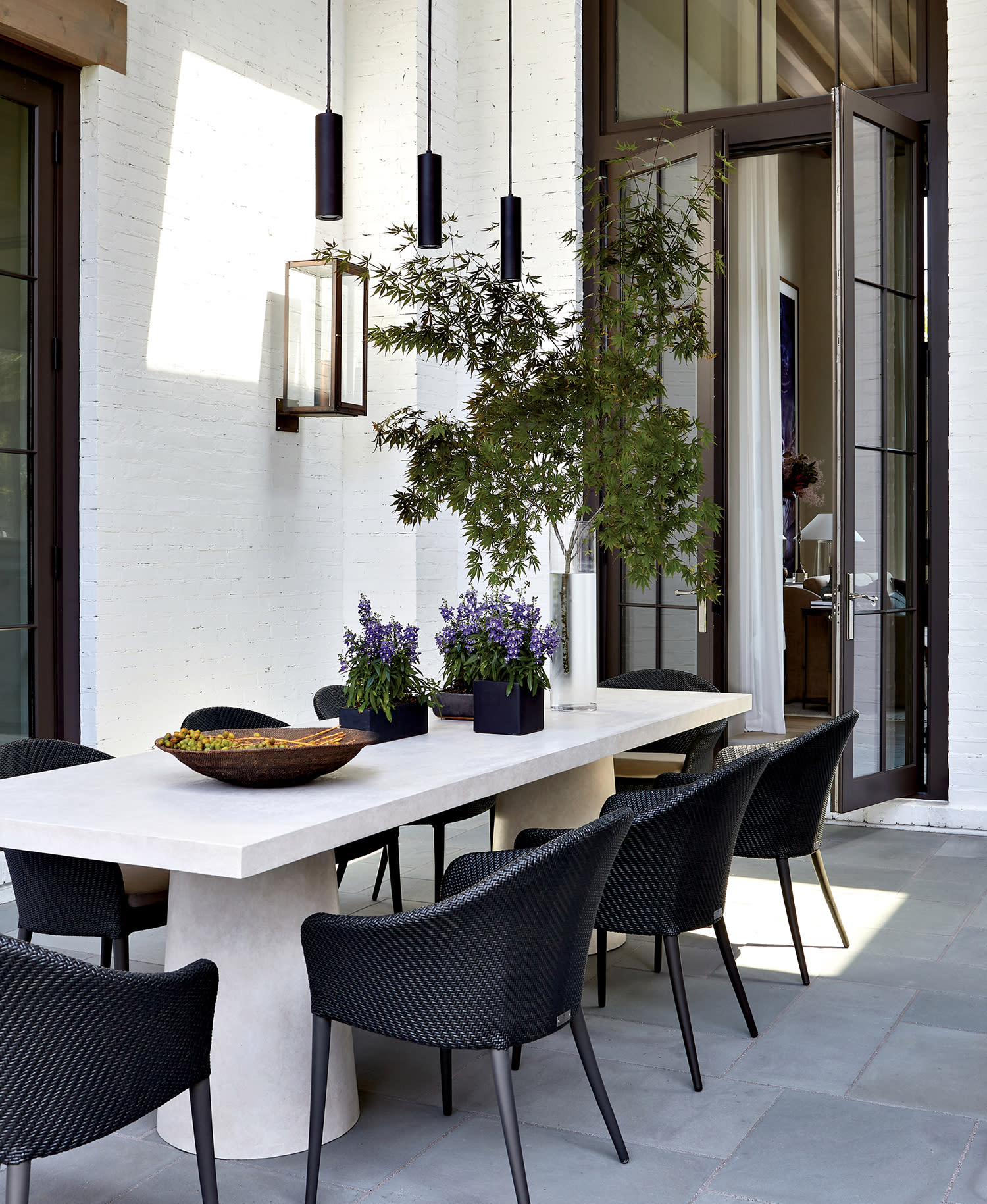 outdoor dining loggia with Janus et Cie chairs around a Robert James Collection table