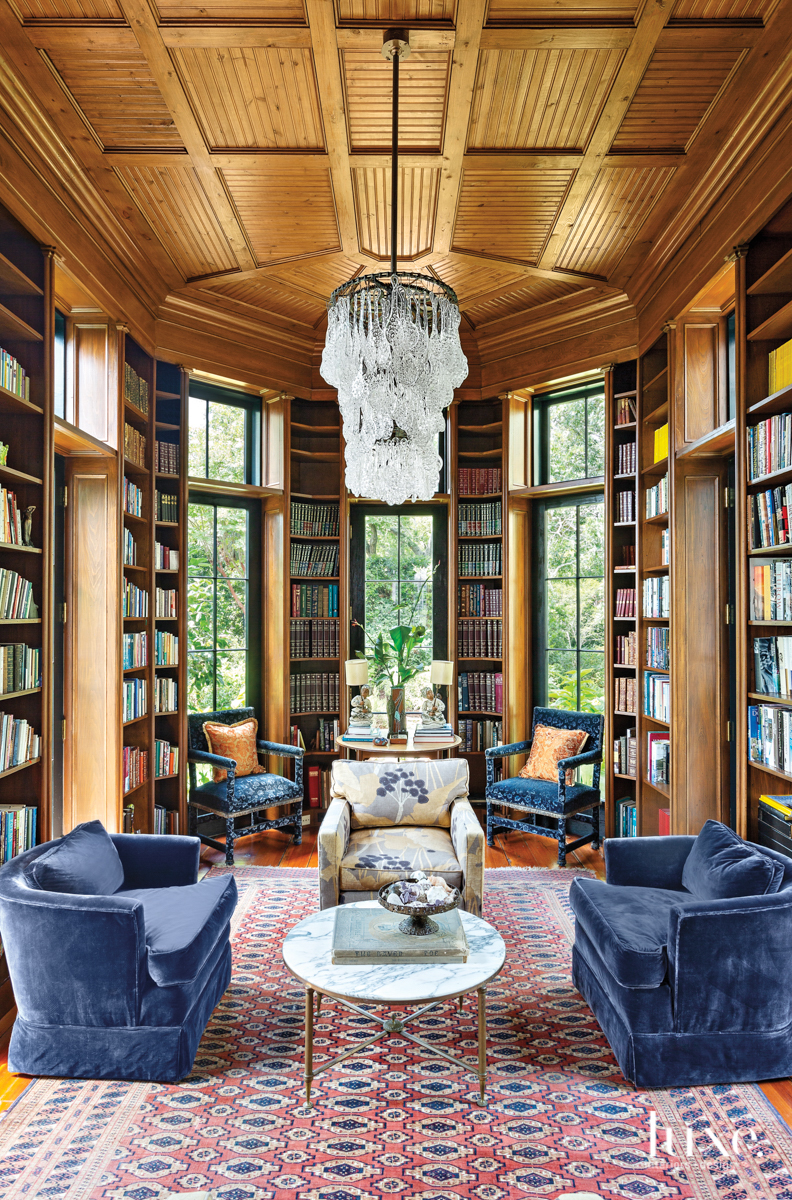 cypress-paneled library with antique blue velvet armchairs