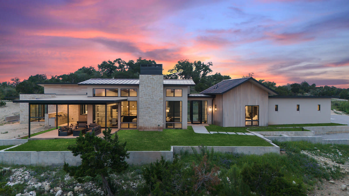 A contemporary house with a spacious lawn, perfect for outdoor activities and relaxation.