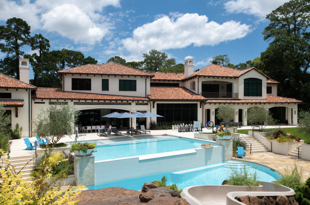 backyard living area built by Houston texas home builder featuring pool