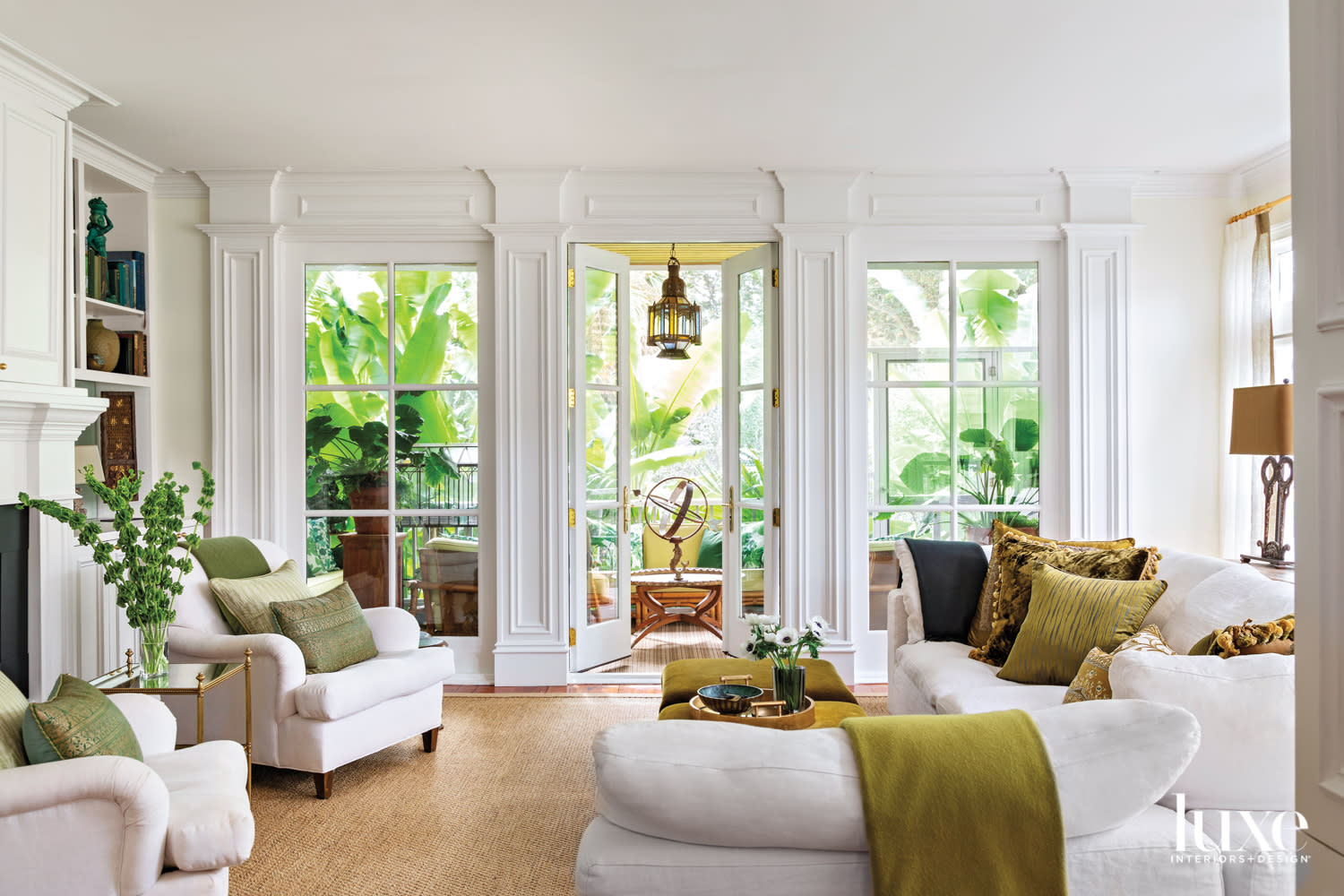 White living room by alexandra howard with large windows opens to lush landscape