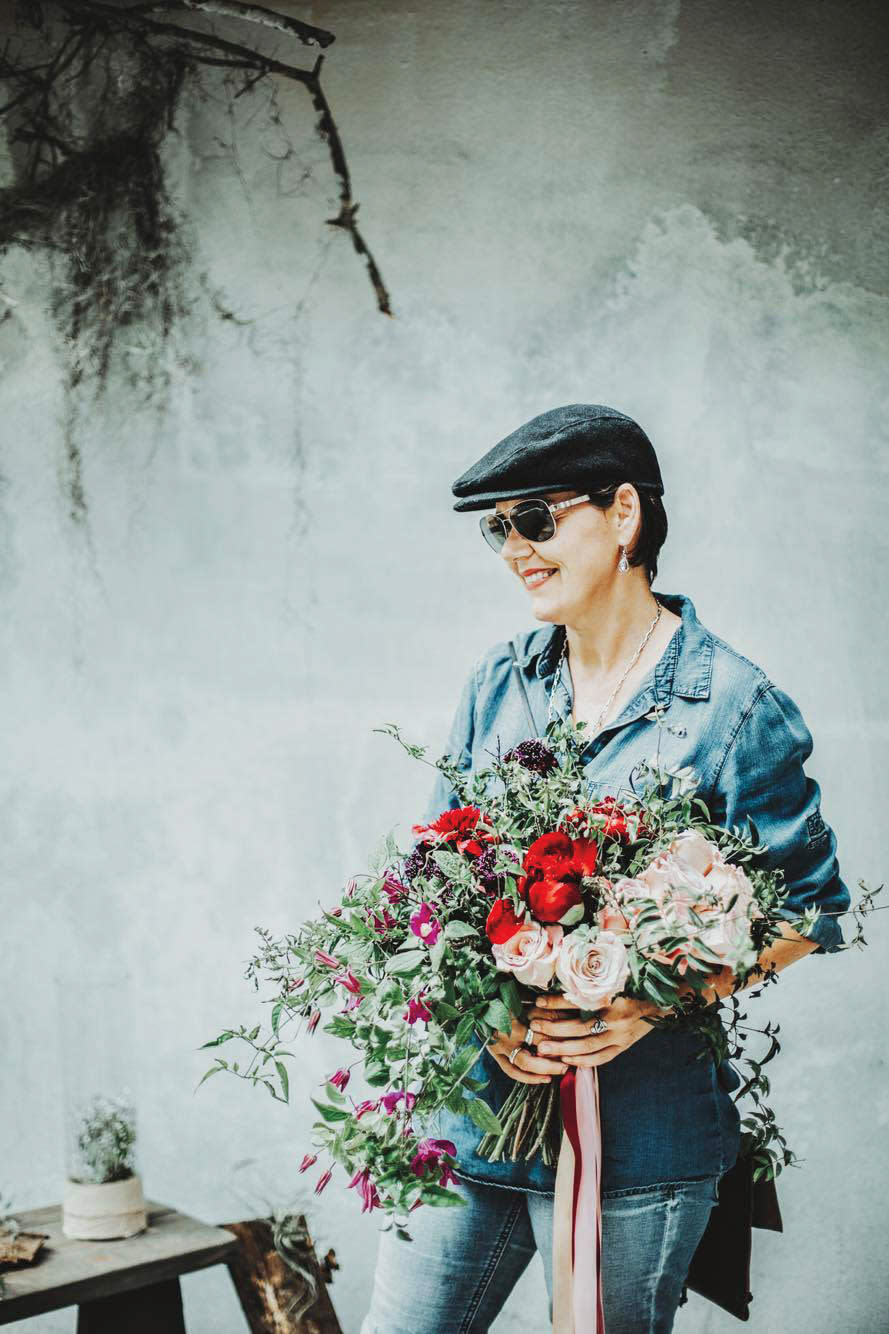 Woman holding red flowers