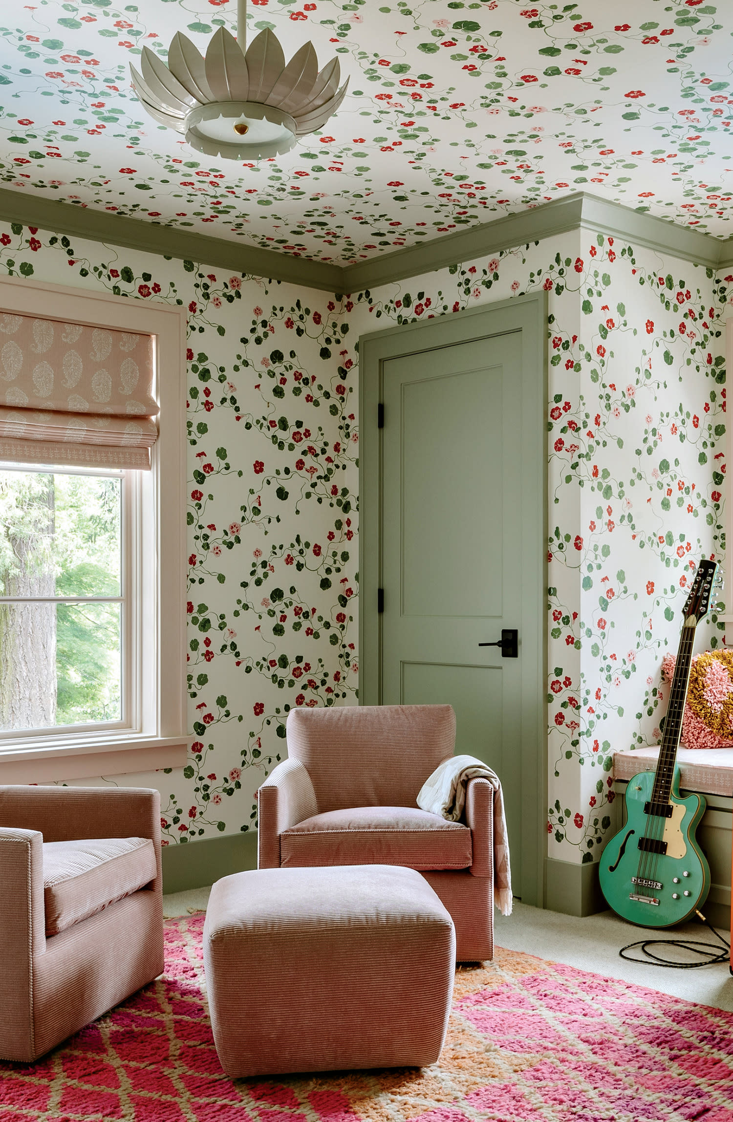 guest bedroom with green and red floral wallpaper