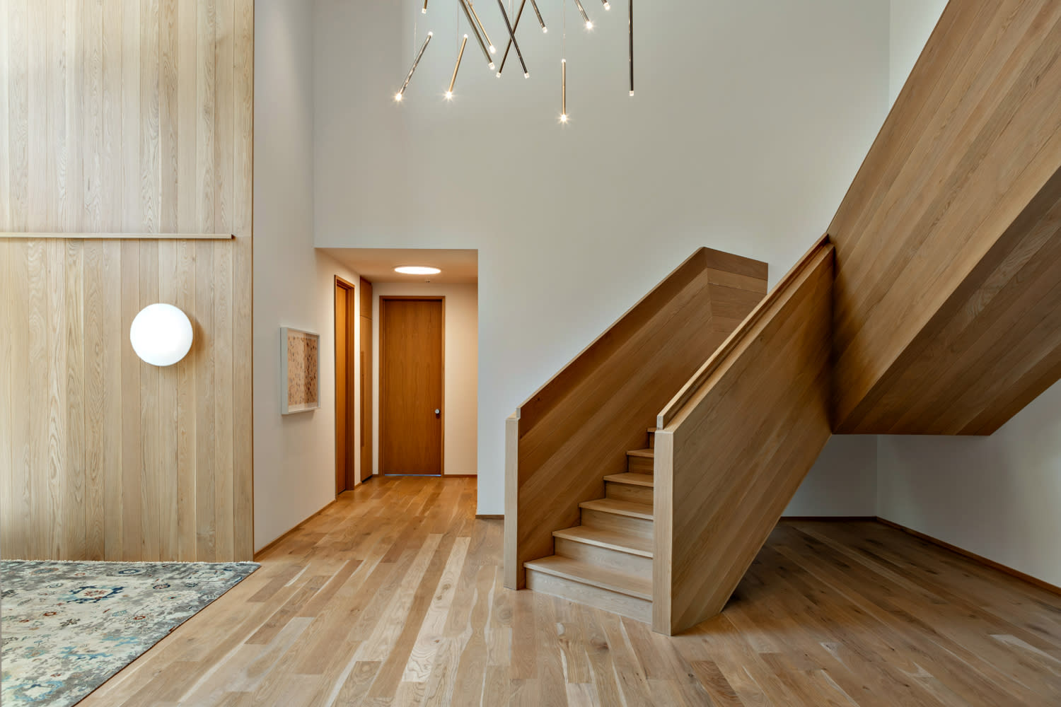 light oak floors and a matching staircase brightens this Nashville home