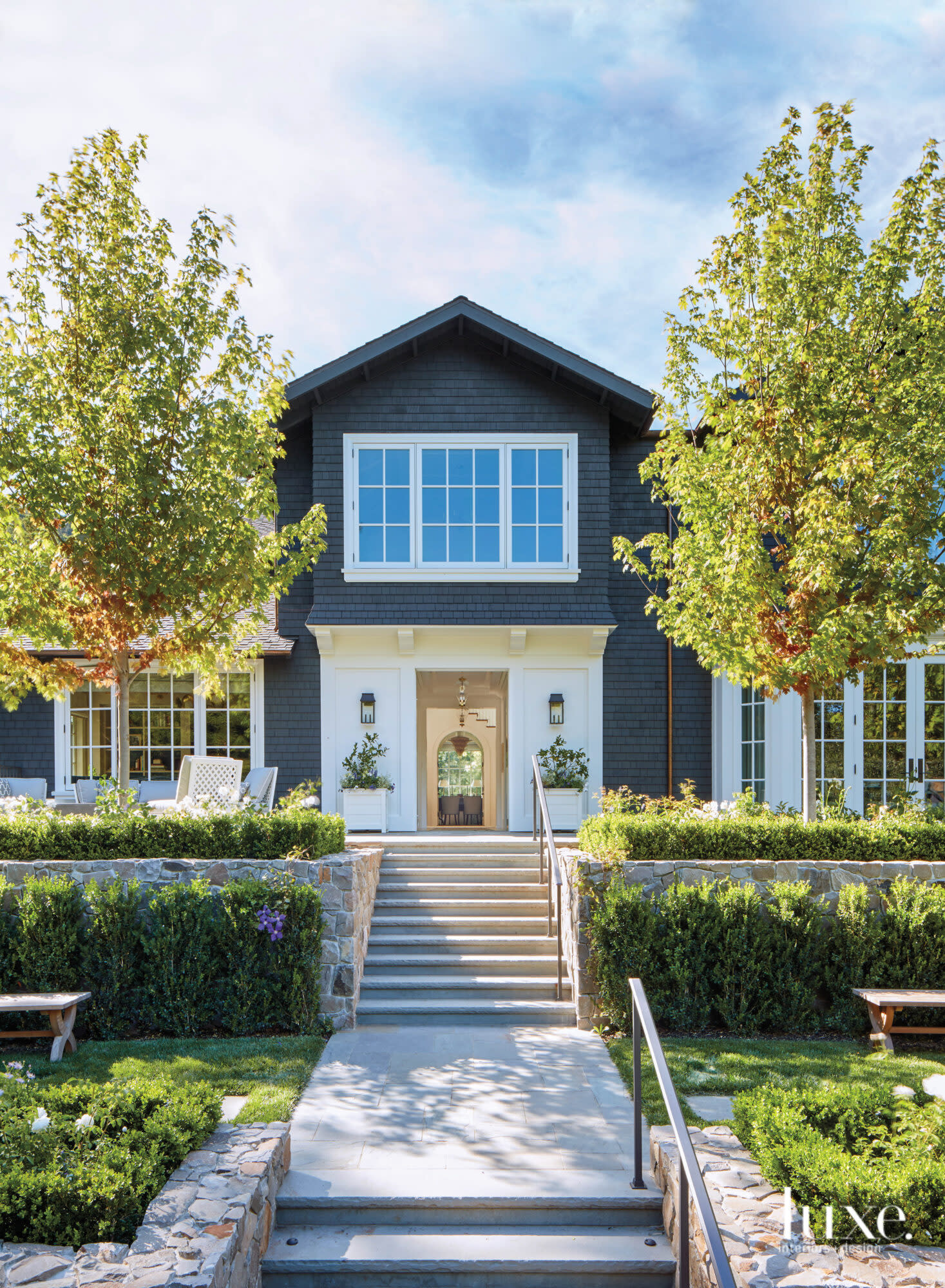 The outside of a Ross, California home is gray and white.