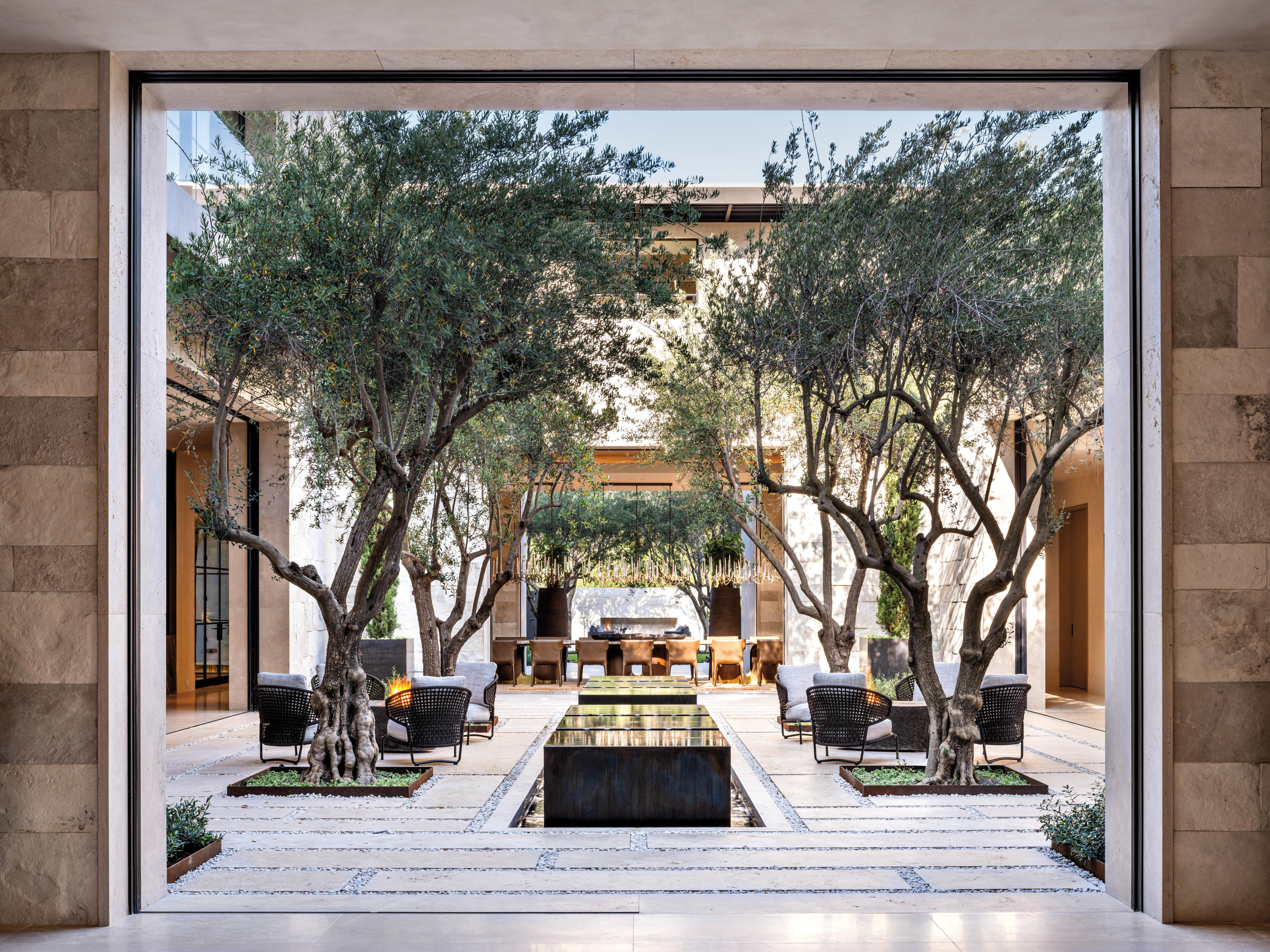 view of mediterranean-inspired home's shaded outdoor courtyard with water feature